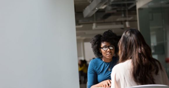 Job Interview - Woman Wearing Blue Top Beside Table