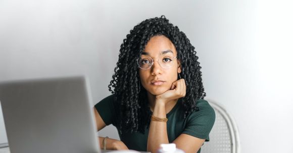 Job Search Emailing - Serious ethnic young woman using laptop at home