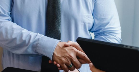 Interview Strategies. - Entrepreneurs shaking hands after agreement