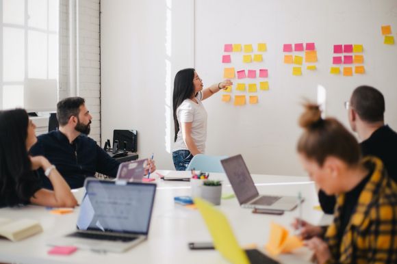 Job - woman placing sticky notes on wall