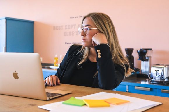 Recruiter - woman in black long sleeve shirt wearing black framed eyeglasses using macbook