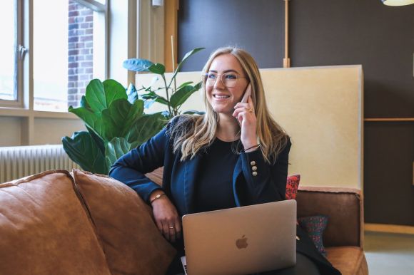 Recruiter - woman in blue long sleeve shirt using silver macbook