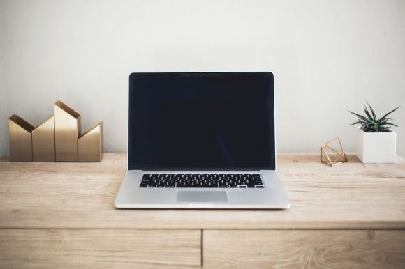 Laptop - MacBook Pro on top of brown table